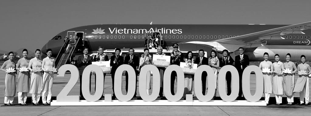 Dương. l Thứ trưởng Nguyễn Nhật (thứ 2 trái qua) cùng lãnh đạo Vietnam Airlines đón vị khách thứ 20 triệu tại chân cầu thang máy bay.